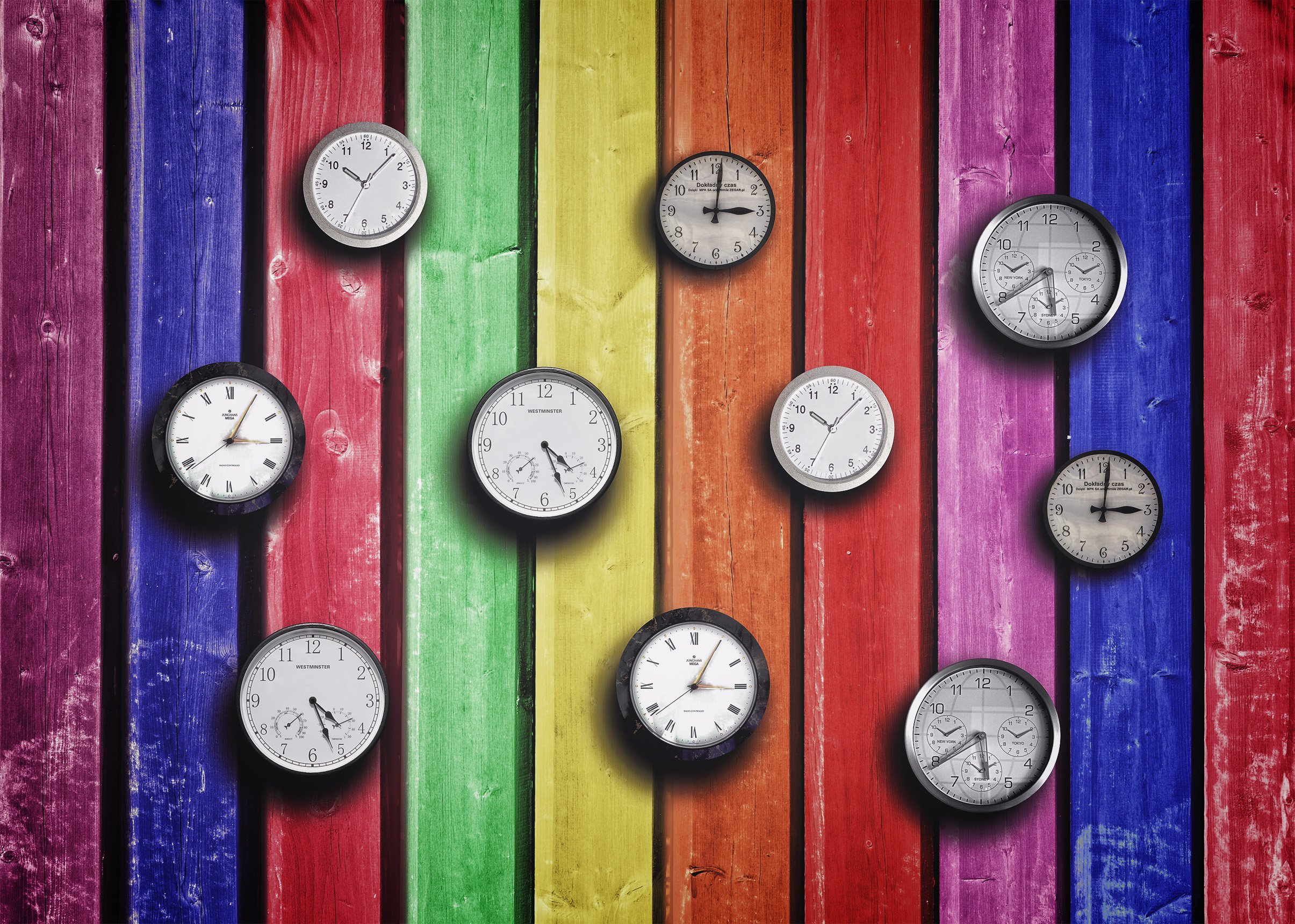 clocks_on_colorful_wood_background_time_concept.jpg