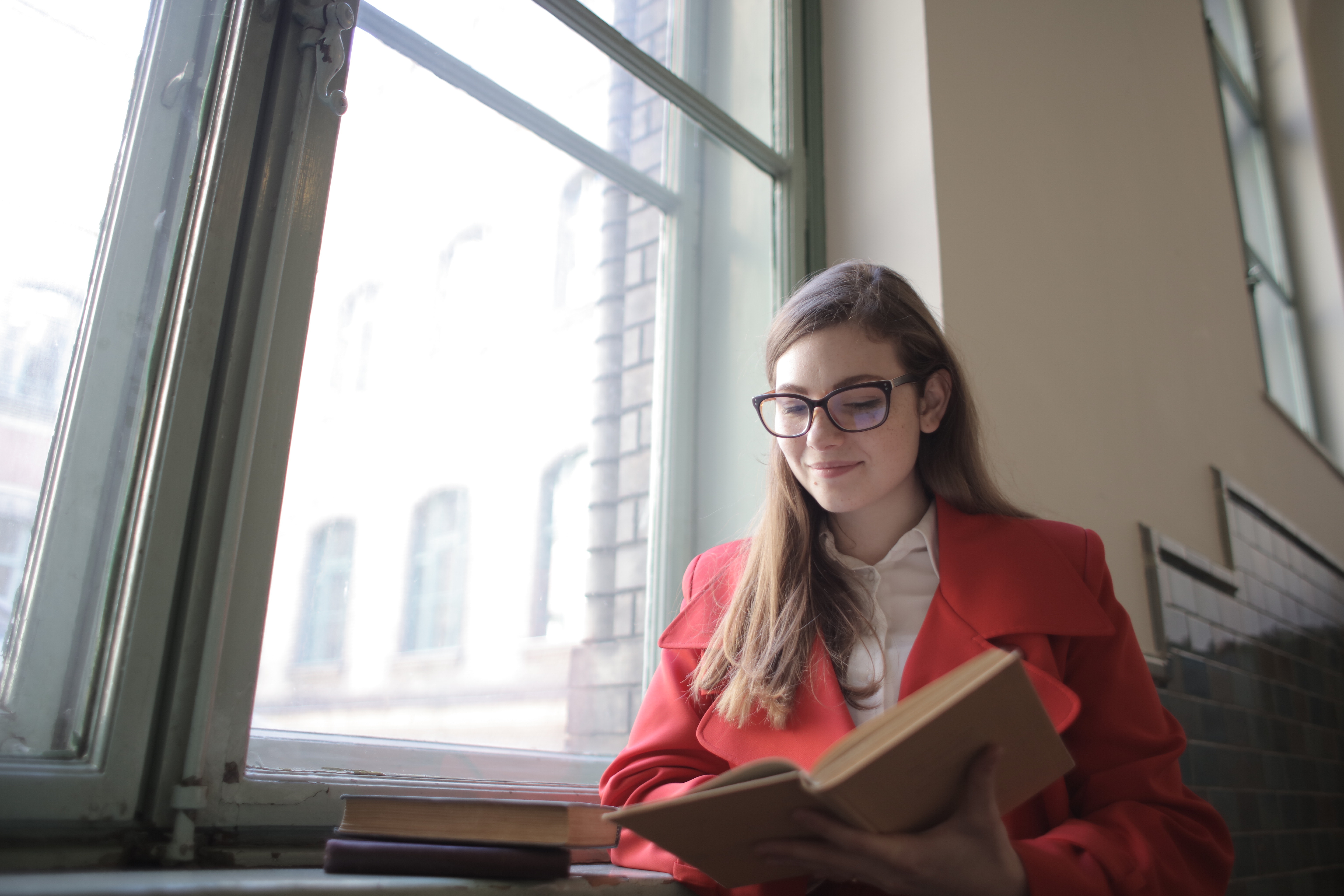 woman-in-red-blazer-reading-book-3791687.jpg