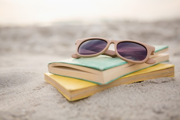 sunglasses-books-sand_1252-537.jpg