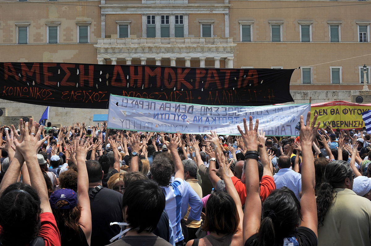 1200px-20110629_moutza_demonstrations_greek_parliament_athens_greece.jpg