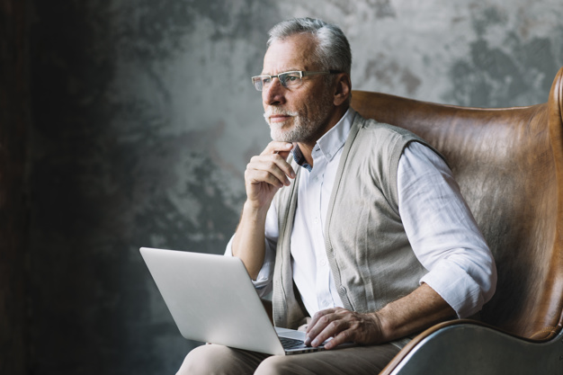 contemplated-elderly-man-sitting-chair-with-laptop-against-grunge-background_23-2147901042.jpg
