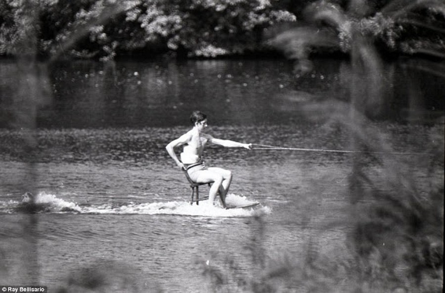1970_prince_charles_in_june_1970_whizzing_across_the_lake_at_sunninghill_park_on_a_chair_balanced_on_a_table.jpg