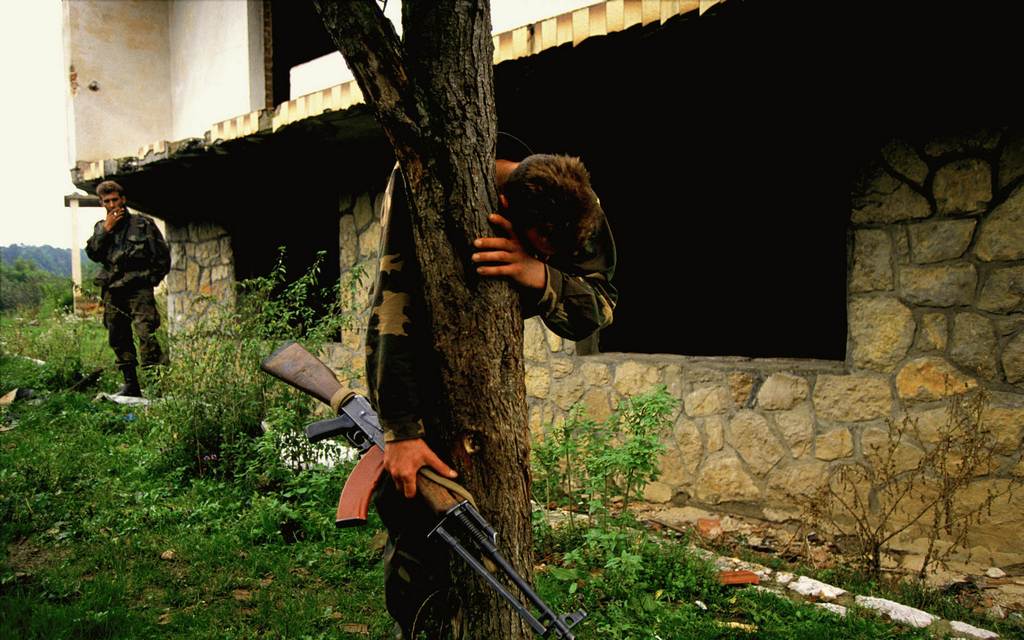 1995_a_bosnian_soldier_stands_on_what_is_believed_to_be_a_mass_grave_outside_his_destroyed_home_he_was_the_sole_survivor_of_69_people.jpg