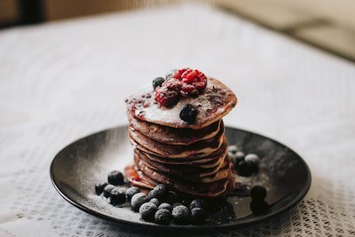 canva_pancakes_with_blueberries_on_black_plae.jpg