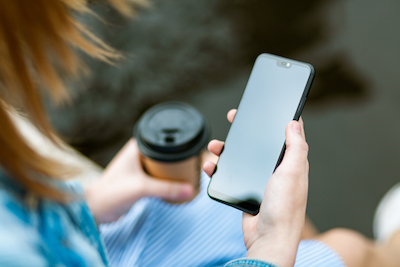 canva_woman_holding_black_smartphone_with_black_screen.jpg