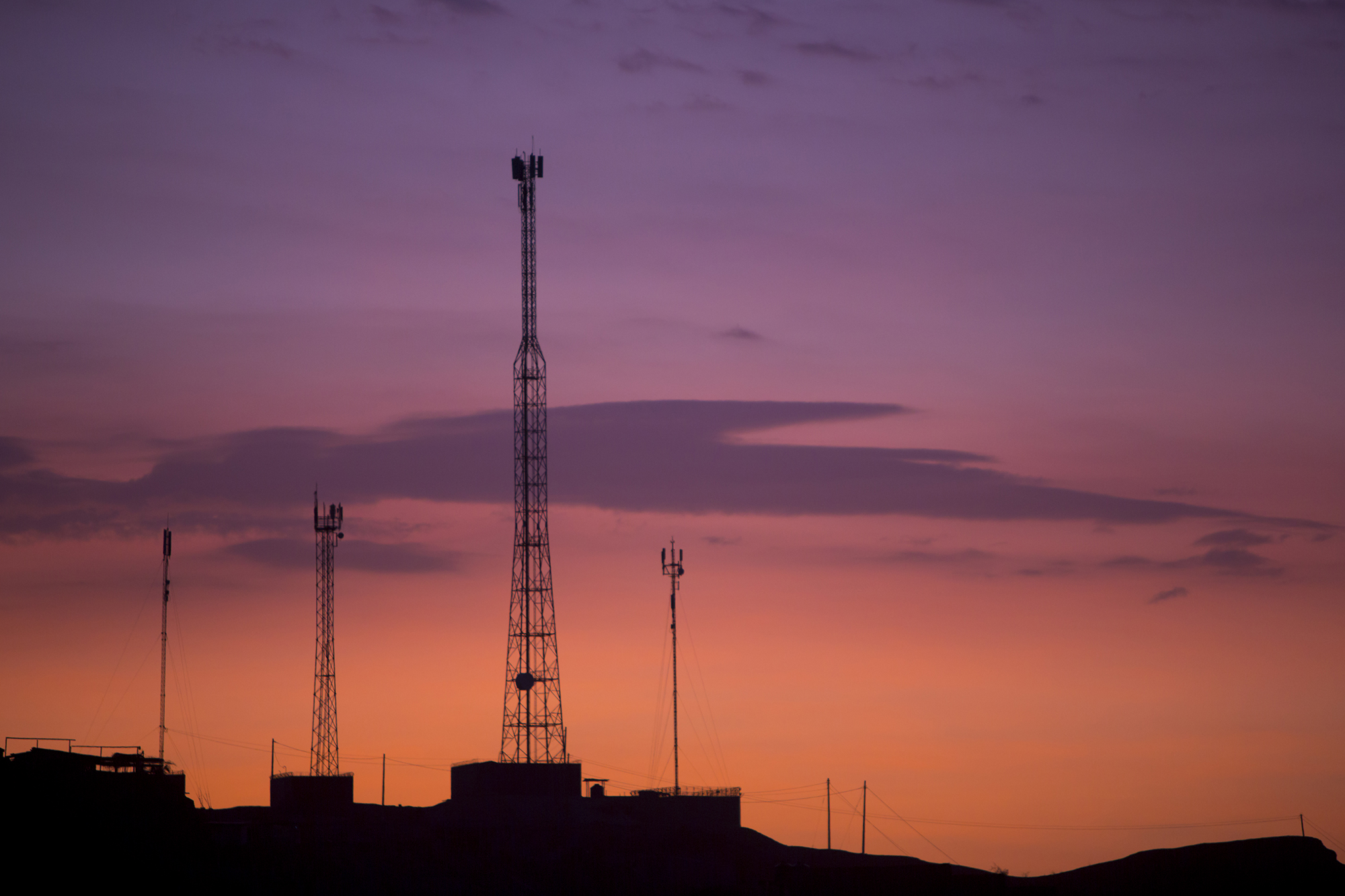communication-towers-on-orange-purple-sky-pkhhjc9.jpg
