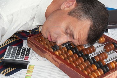 8277923-the-tired-engineer-smetchik-has-fallen-asleep-directly-on-abacus-after-the-heavy-working-day.jpg