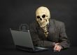 7541363-the-terrible-skeleton-in-a-suit-sits-at-black-office-with-the-laptop.jpg