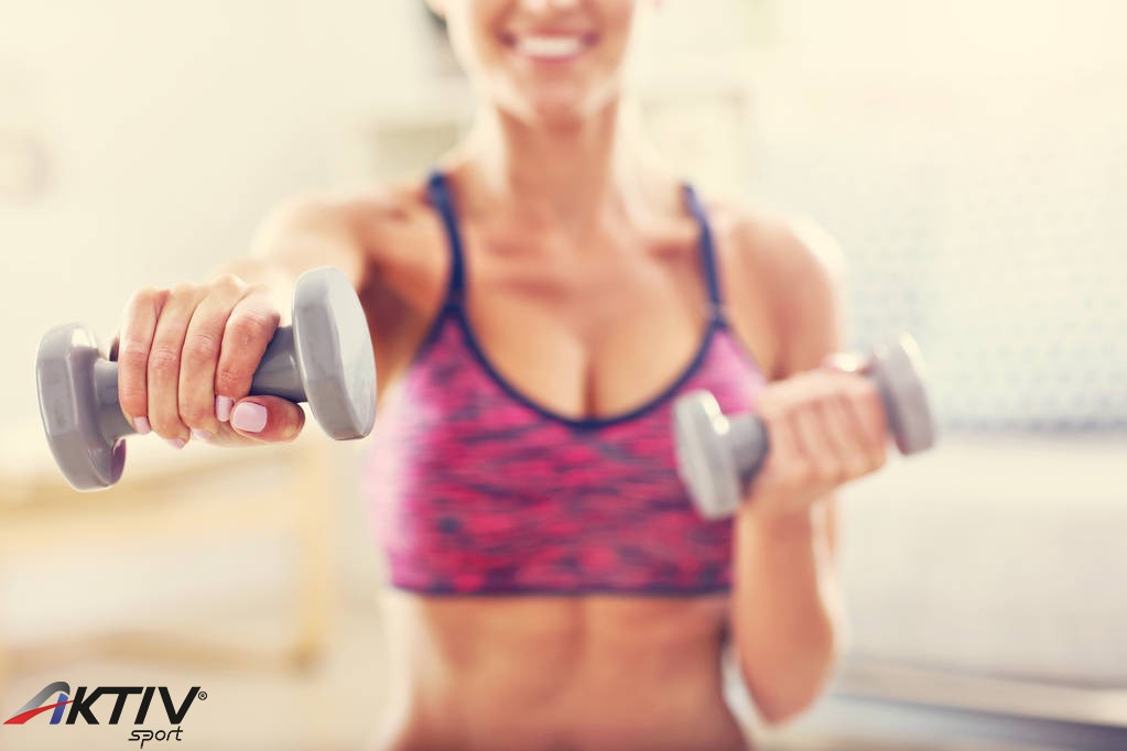 stock-photo-woman-exercising-with-dumbbells-at.jpg