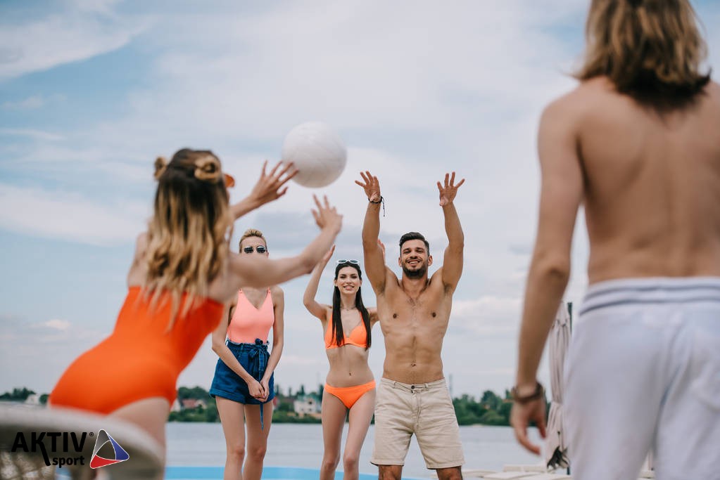 stock-photo-young-men-women-playing-volleyball.jpg