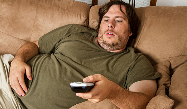 overweight-man-couch-tv-thinkstockphotos-177537883.jpg