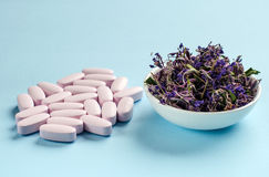 alternative-medicine-pills-herbs-soft-pink-color-dried-fireweed-white-saucer-light-blue-background-herbal-tea-74699257.jpg