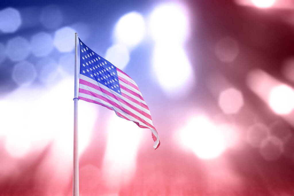 stock-photo-american-flag-waving-blurred-light.jpg