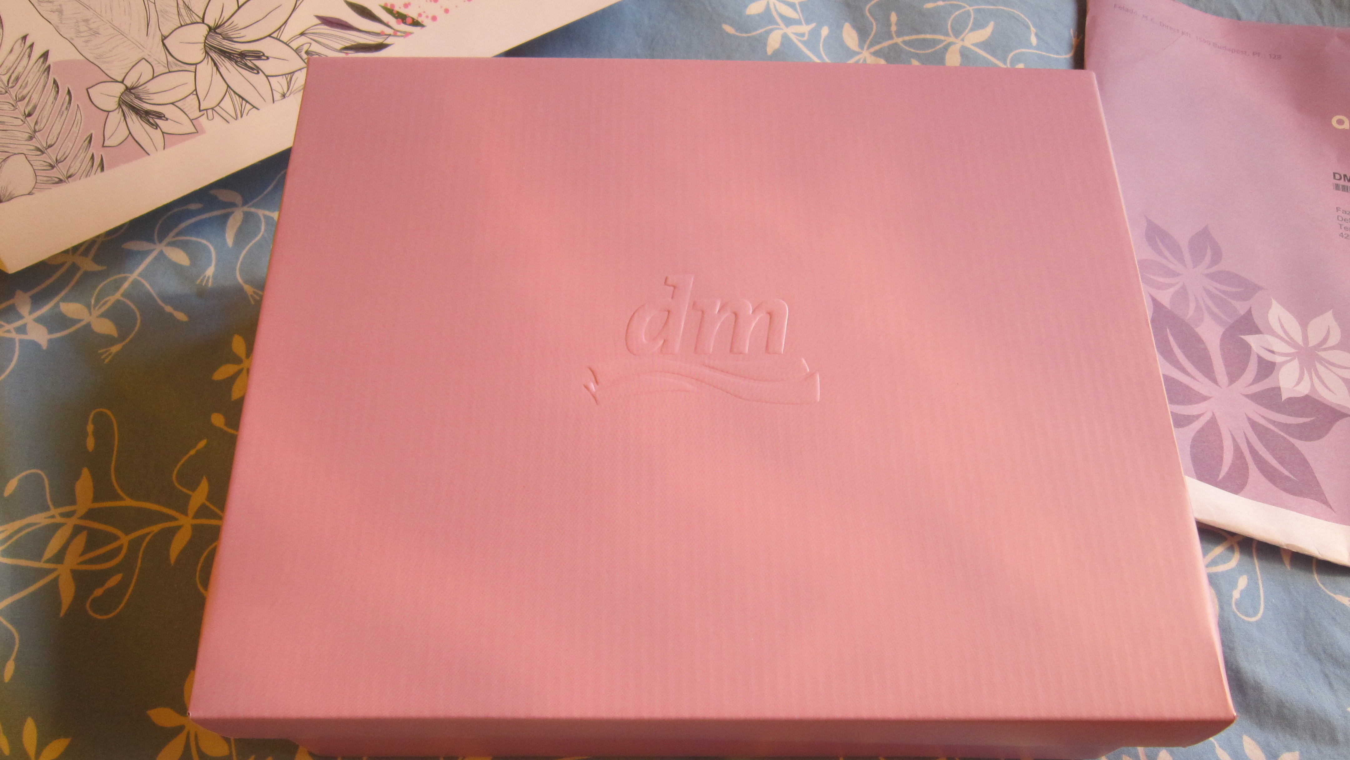 A nagy dobozban kisebb doboz dombornyomott DM logóval; tisztára mint egy matrjoska baba. :)