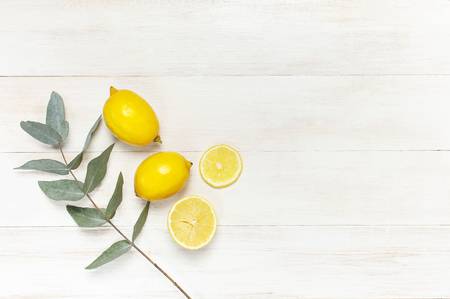 113082565-whole-and-sliced-fresh-lemon-eucalyptus-leaves-on-white-wooden-background-flat-lay-top-view-copy-spa.jpg