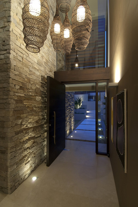 Stone-Wall-and-Cool-Hanging-Lamp-at-Modern-Waterfront-House-Design-by-Bruce-Stafford-Architects.jpg