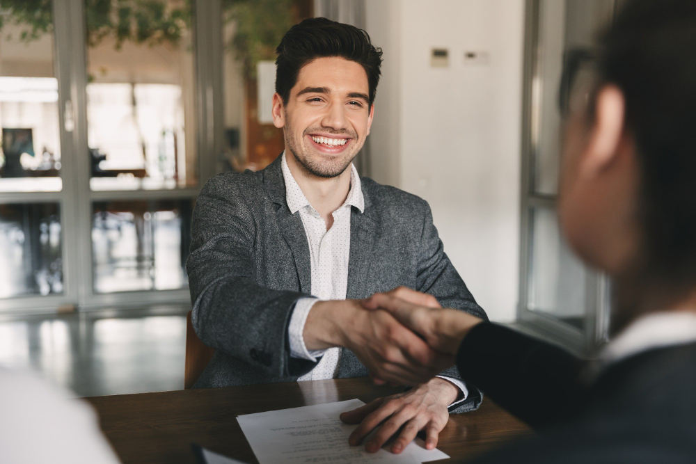 business-career-placement-concept-happy-caucasian-man-30s-rejoicing-shaking-hands-with-employee-when-was-recruited-during-interview-office.jpg