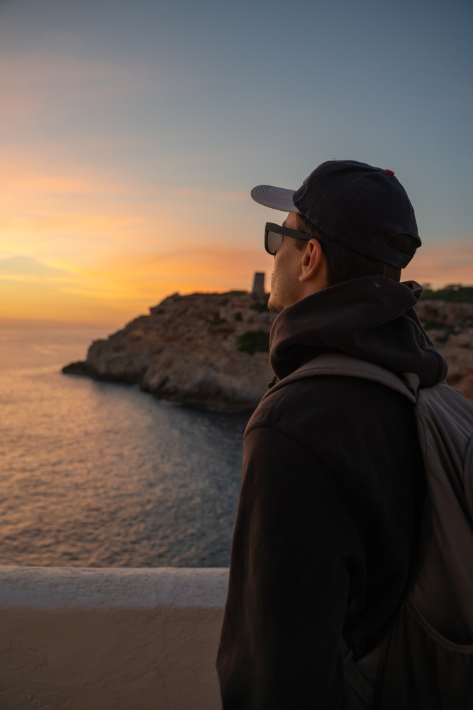caucasian-man-with-cap-sunglasses-looking-horizon-sea-cliff-palma-de-mallorca-spain.jpg