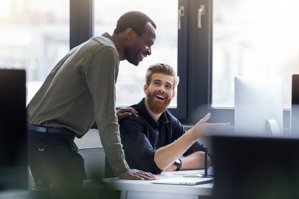 two-happy-men-working-together-new-business-project.jpg