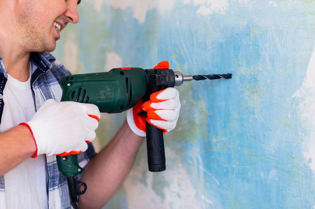 man-holding-hammer-drill-wall_23-2148384494.jpg