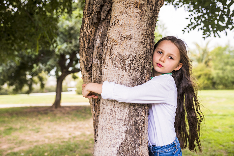 close-up-adorable-girl-hugging-tree-trunk.jpg