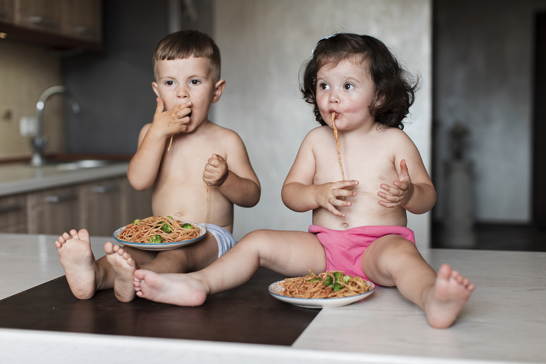 cute-young-siblings-eating-pasta.jpg