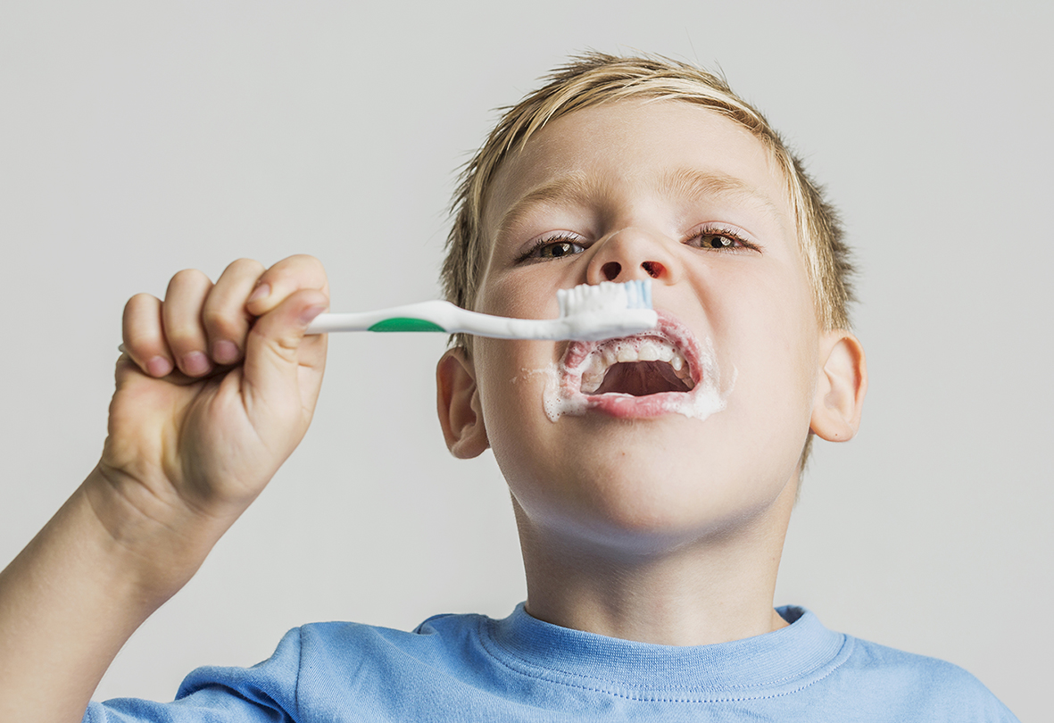 low-angle-kid-brushing-his-teeth.jpg