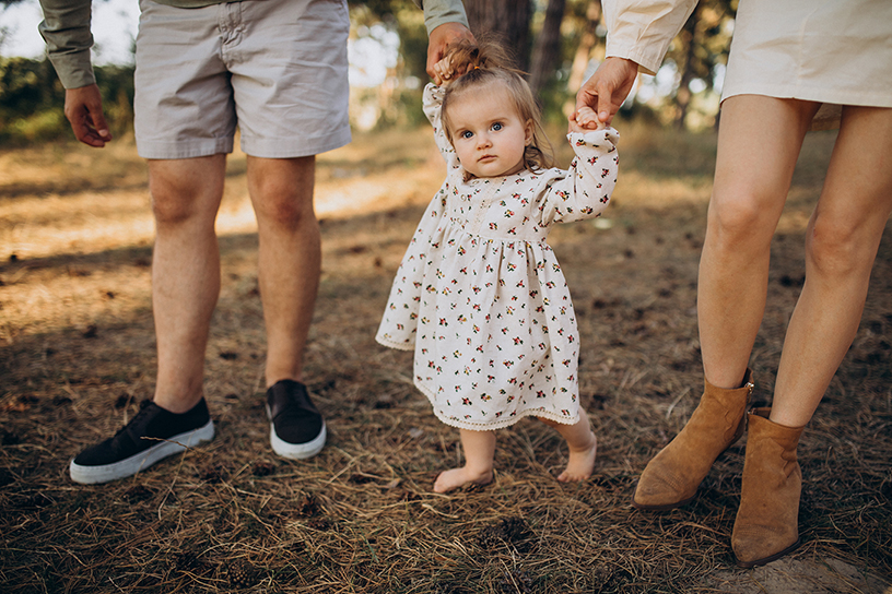 young-family-with-cute-little-daughter-walking-forest-sunset.jpg