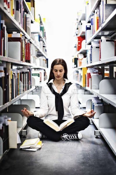 10014486_stock-photo-student-meditating-over-a-book-in-library.jpg