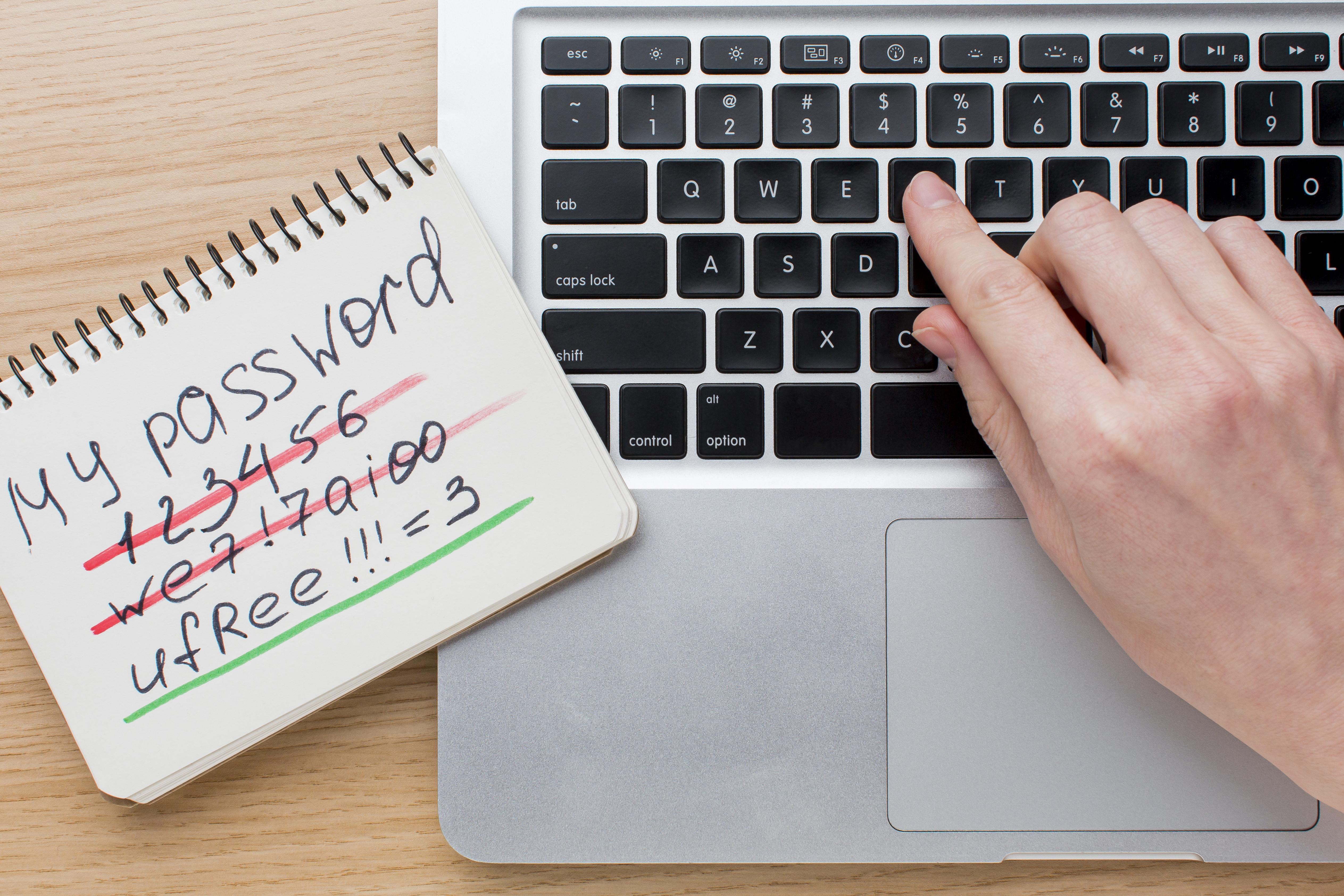 flat-lay-laptop-with-hands-notebook-with-password-information.jpg