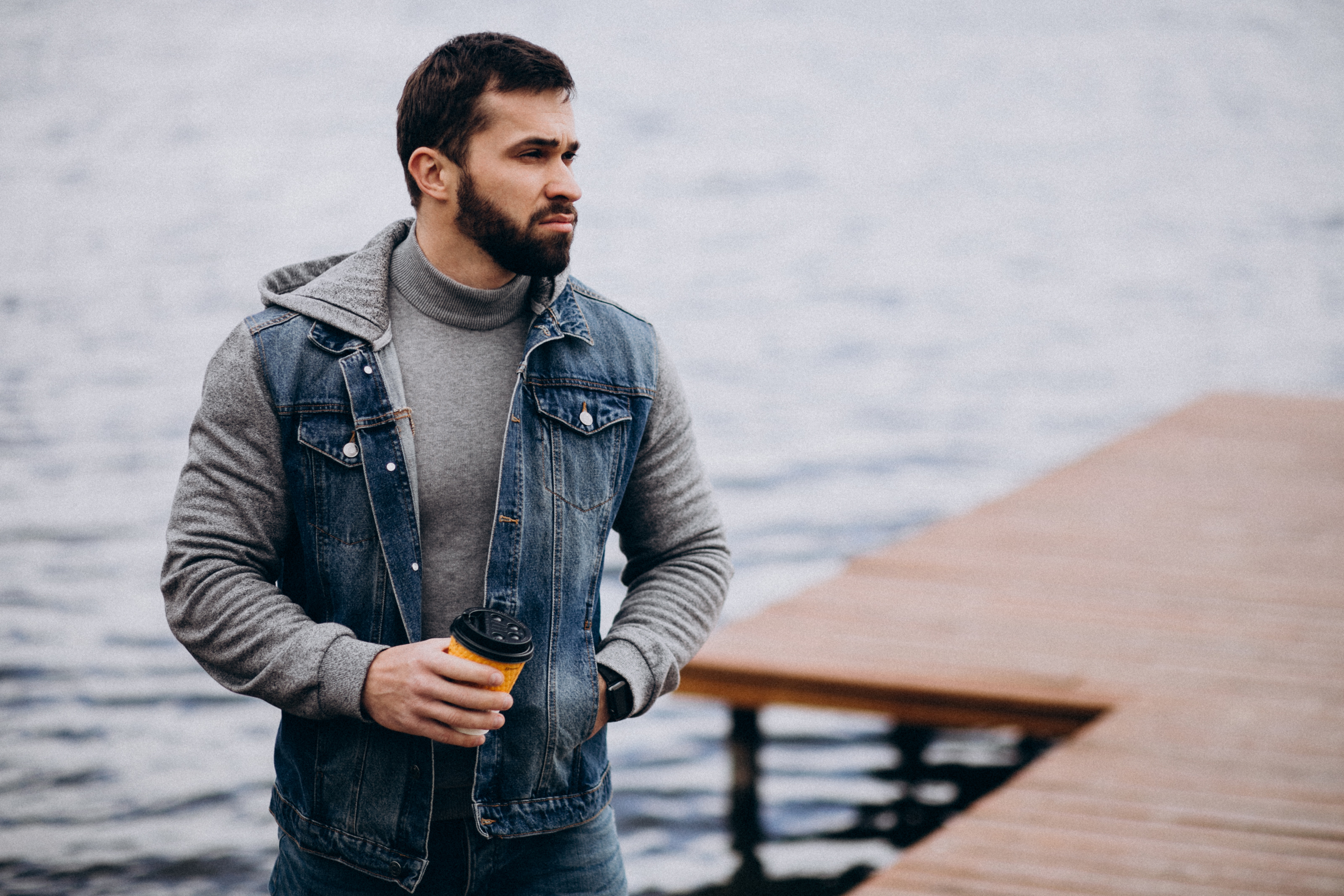 good-looking-bearded-man-drinking-coffee-by-river-park.jpg