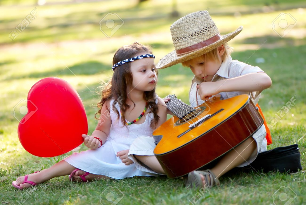 10778560-young-couple-with-guitar-on-grass-in-park.jpg