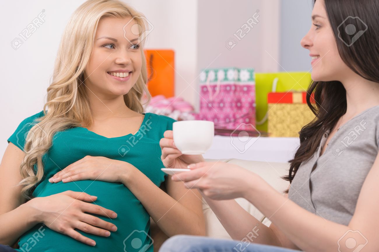 23412263-pregnant-woman-on-baby-shower-party-beautiful-young-women-talking-to-her-friend-and-d.jpg