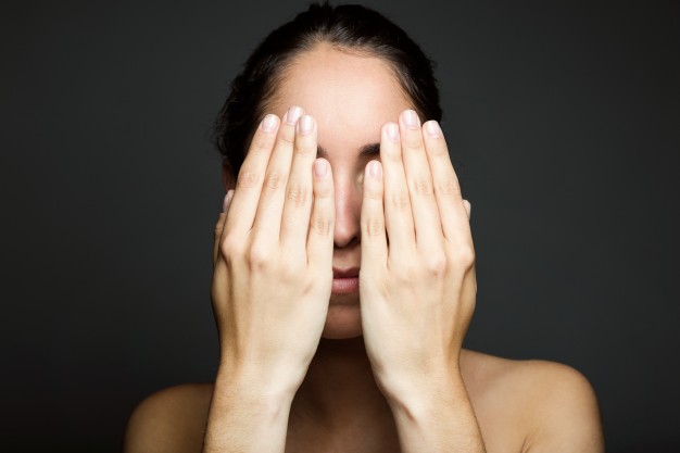 young-woman-covering-half-of-her-face-with-a-hand_1301-4021.jpg