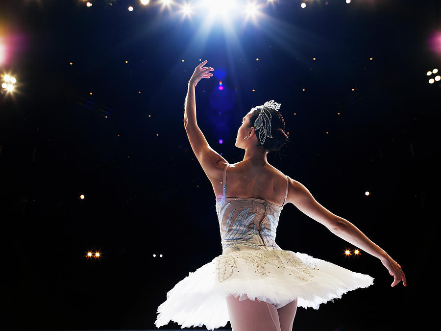 ballerina-dancing-on-stage-arm-raised-thomas-barwick.jpg