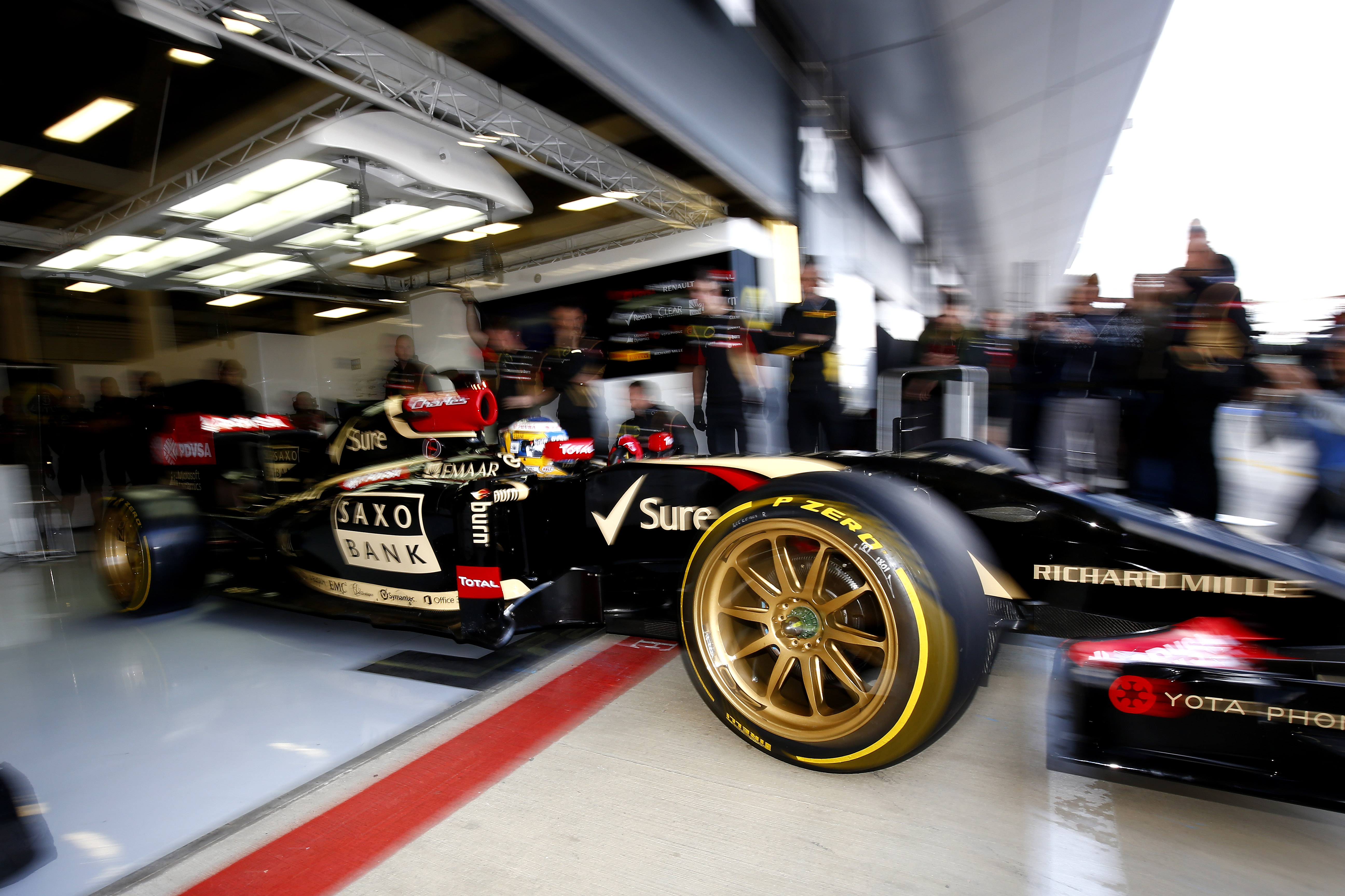 the_lotus_team_f1_car_on_18_inch_tyres_drives_out_of_the_garage.jpg