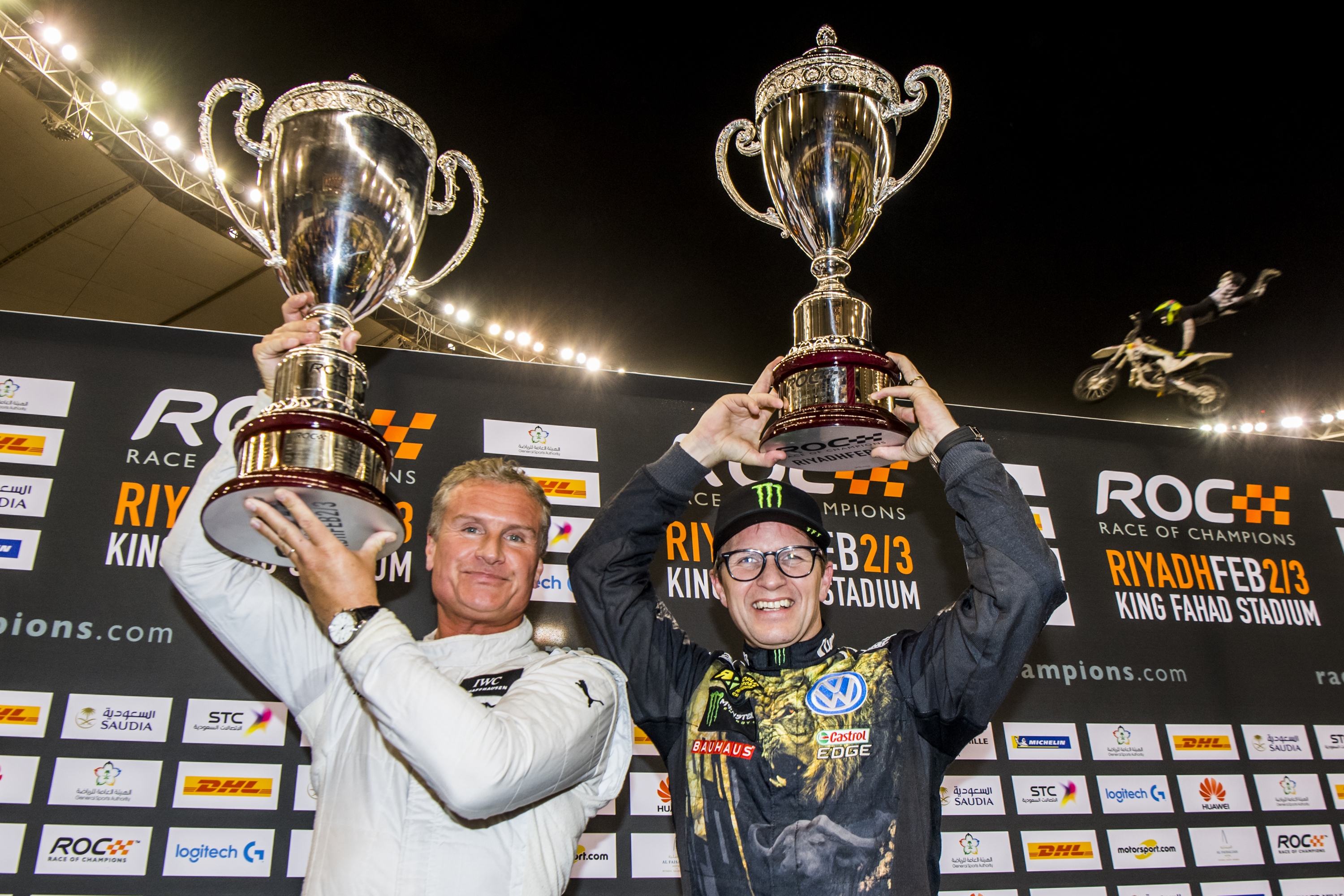 david_coulthard_gbr_celebrates_his_win_with_petter_solberg_nor_on_the_podium_during_the_race_of_champions_on_saturday_3_february_2018_at_king_fahad_stadium_riyadh_saudi_arabia.JPG