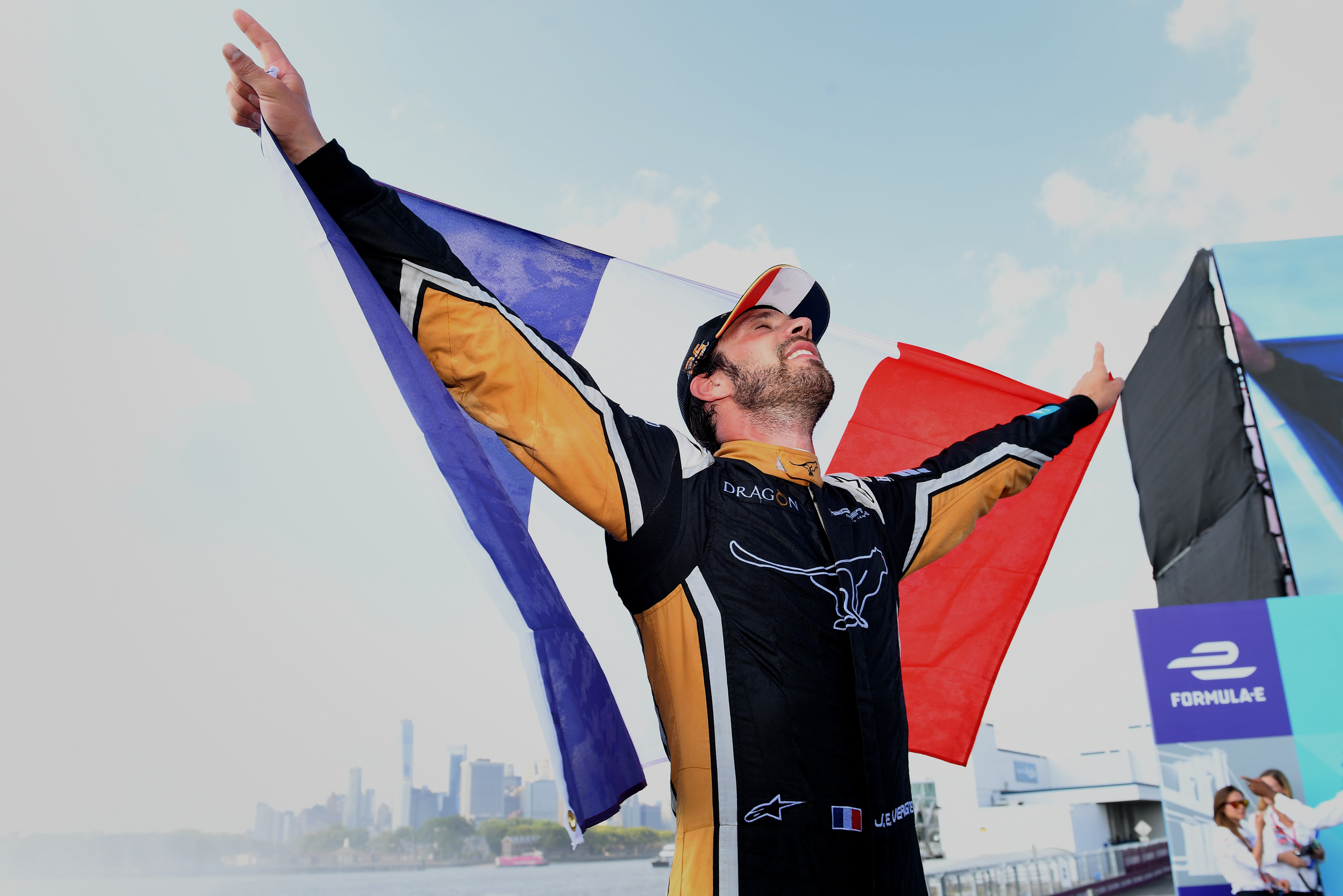 newly-crowned_formula_e_champion_jean-eric_vergne_holding_the_french_flag_aloft_against_the_backdrop_of_the_new_york_skyline.jpg