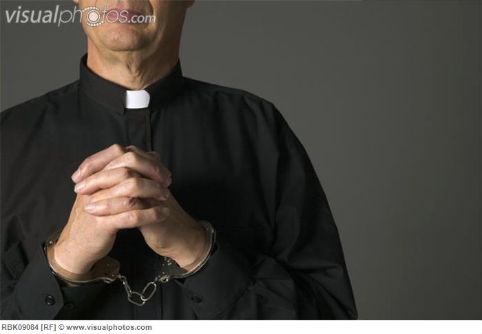 priest_in_handcuffs_praying.jpg