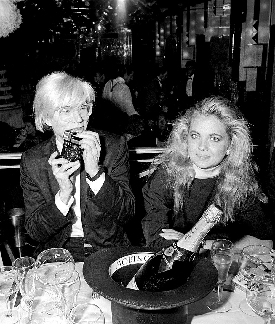 champagneclub_andy_warhol_sharing_a_bottle_of_moet_imperial_at_a_dinner_in_new_york_city_with_socialite_cornelia_guest_1985.jpg
