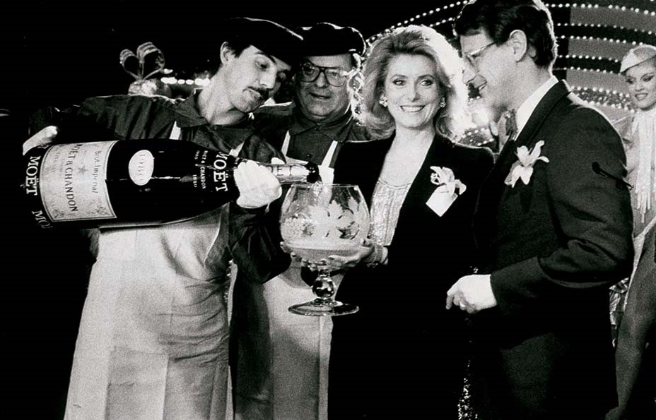 champagneclub_catherine_deneuve_with_moet_chandon_president_yves_benard_during_a_soiree_in_paris_1984.jpg