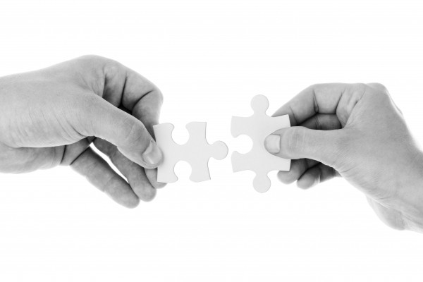 black-and-white-studio-shot-of-hands-holding-jigsaw.jpg