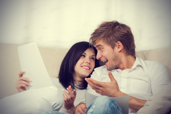 happy-couple-reading-a-letter-in-their-living-room.jpg