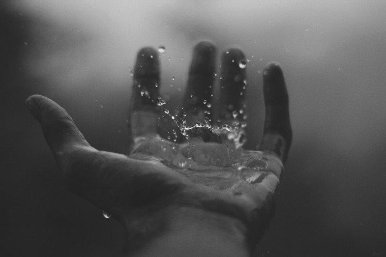 close-up-view-of-water-drops-on-hand-black-and-white-photo-785x523.jpeg
