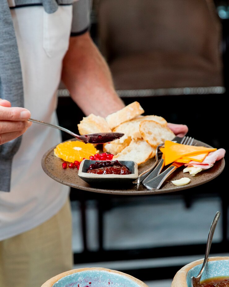 man-puts-some-jam-his-plate_141793-1303.jpg