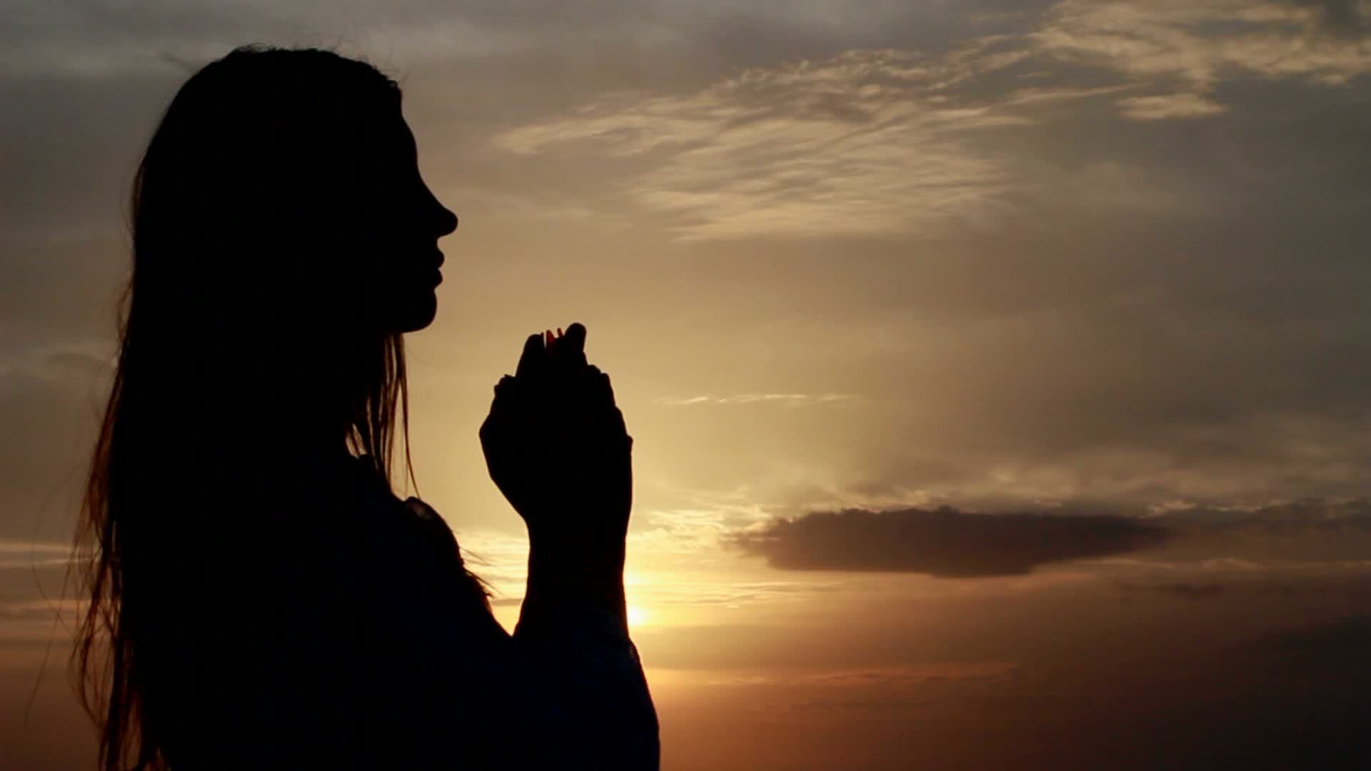 prayer-woman-hands-folded-seaside-footage-022795480_prevstill.jpeg