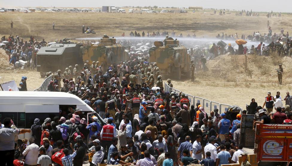 A menekültkérdés másik oldala: a török hadsereg vízágyúkkal próbálja a török-szír határ mentén felállított kerítés mögött tartani az átkelni vágyó szír menekülteket. (f.: Reuters)