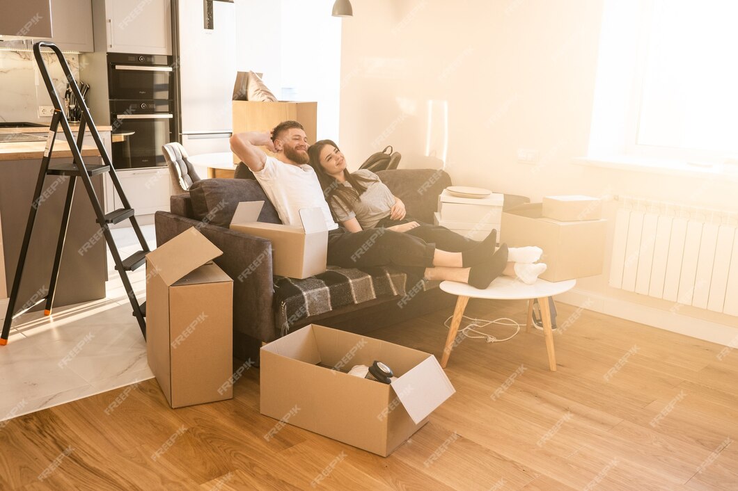 happy-european-couple-sitting-resting-sofa-home-concept-moving-new-flat-idea-young-family-cardboard-boxes-with-things-interior-studio-apartment-sunny-daytime_341052-3002.jpg