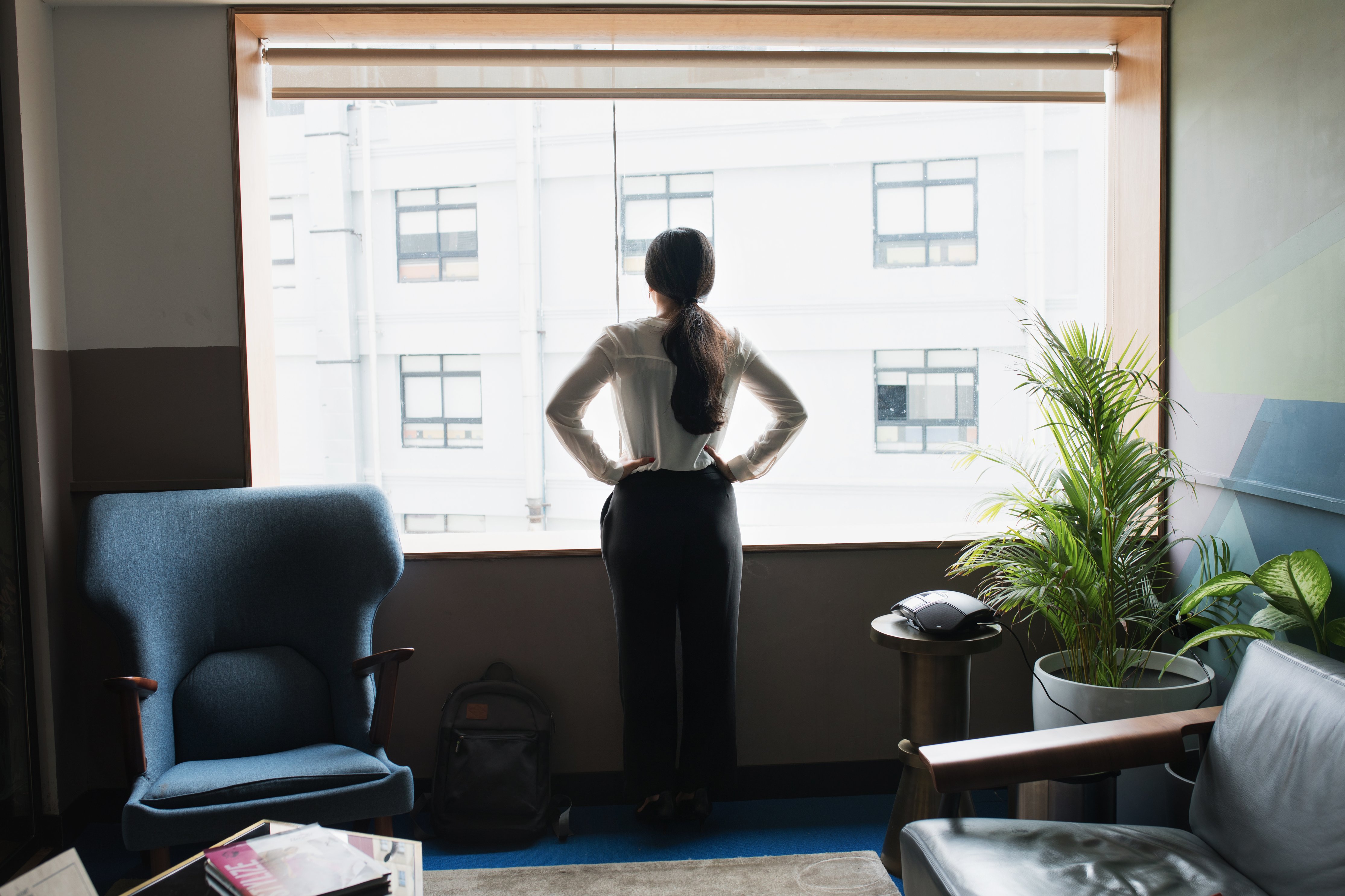 female-executive-looks-out-modern-office-window.jpg