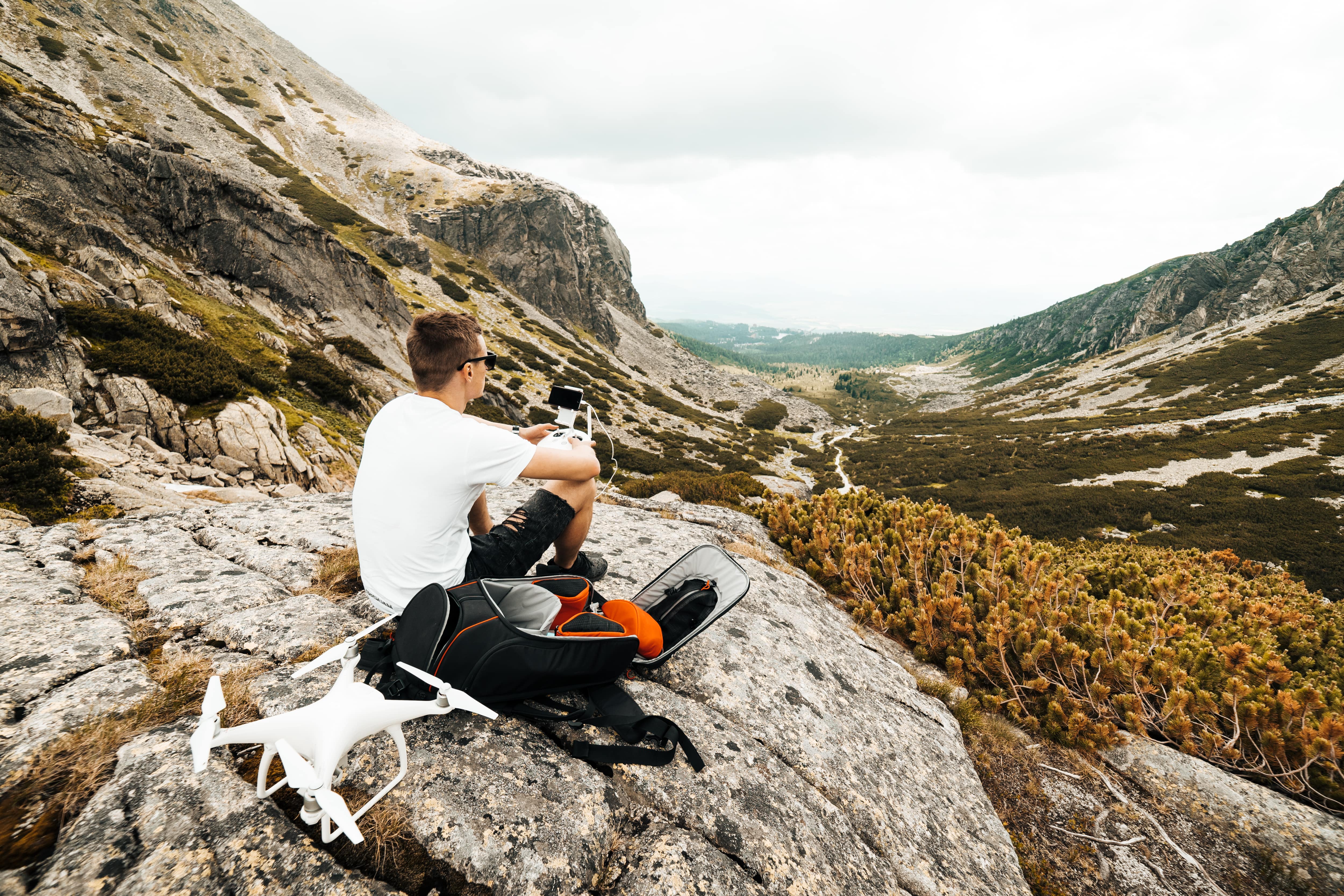 man-setting-up-a-drone-for-aerial-photography-in-mountains-picjumbo-com-min.jpg